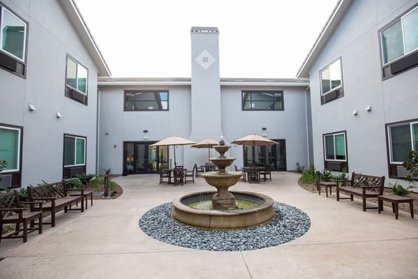 Garden courtyard with a fountain and seating area