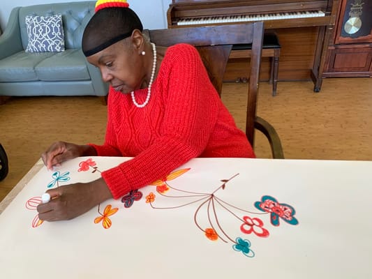 Resident engaging in a creative activity indoors