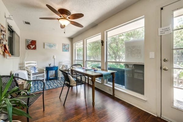 Bright common area with indoor plants and dining table