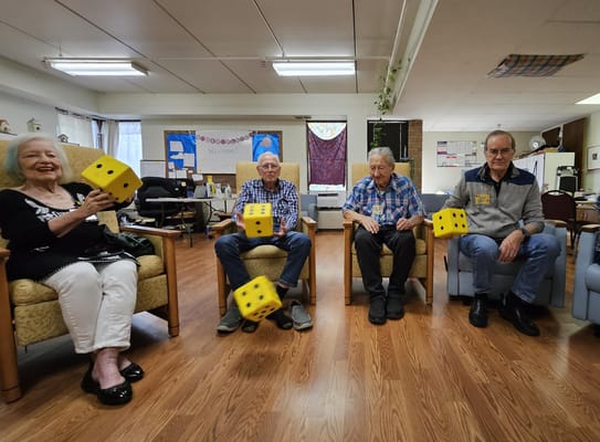 Residents playing a dice game in a common area
