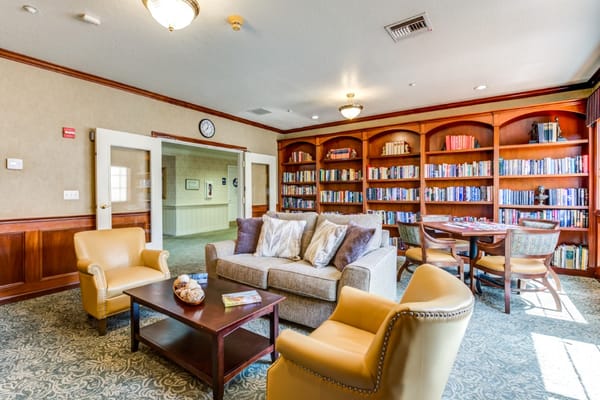 Bright common area with bookshelves and comfortable seating