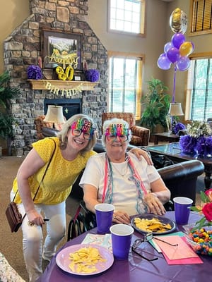 Residents celebrating a birthday in a decorated common area