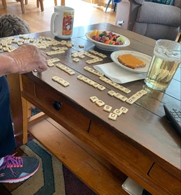 Resident enjoying a game with snacks and drinks