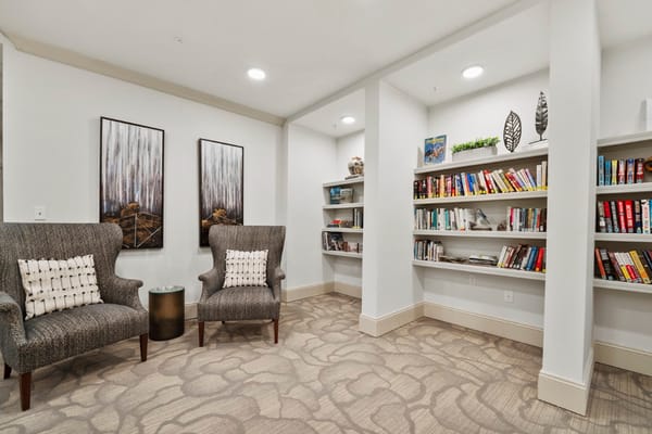 Cozy reading area in a common room with bookshelves
