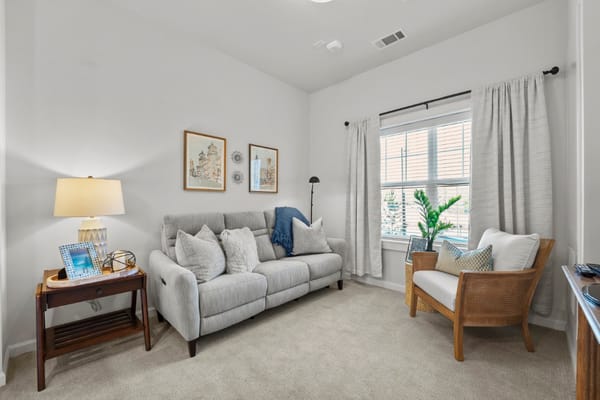 Cozy living area in a resident room with natural light