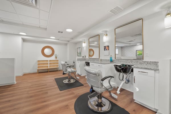 Empty salon chairs in a well-lit interior space
