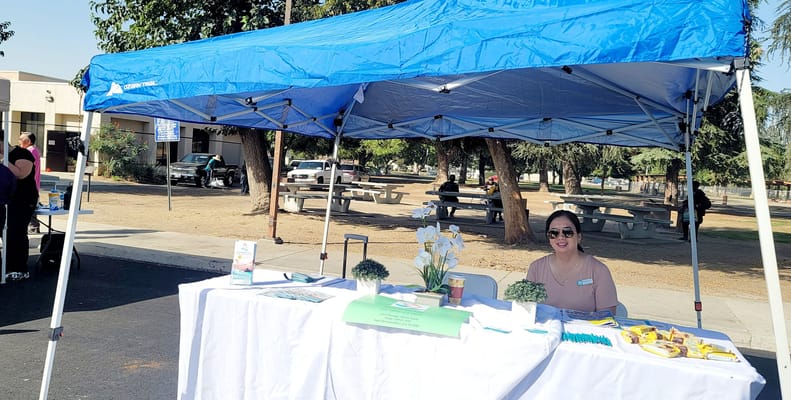 Staff member at a tent promoting senior care services