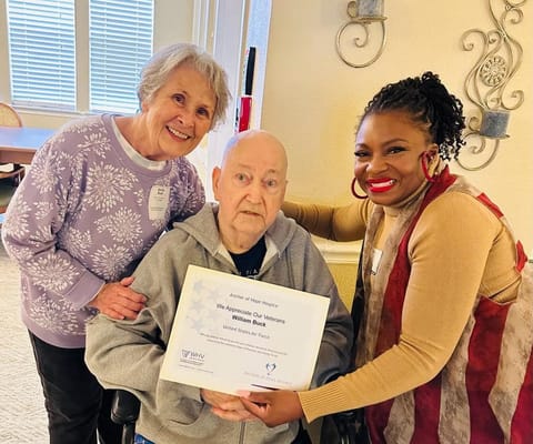 Staff members celebrating a resident's achievement