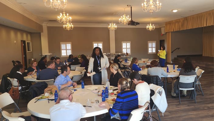 Residents and staff participating in a meal event in a common area