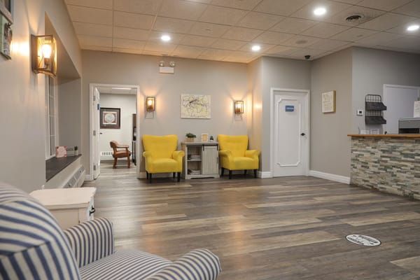 Bright common area with yellow chairs and a welcoming atmosphere