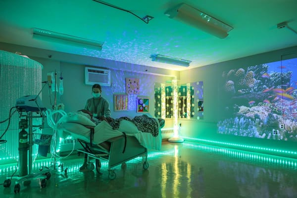 Healthcare staff assisting a resident in a soothing environment