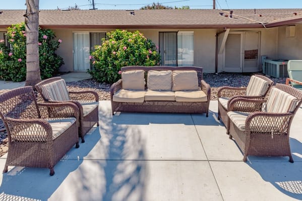 Outdoor seating area with wicker furniture and plants