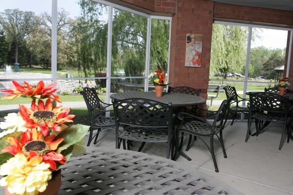 Outdoor patio area with flowers and tables