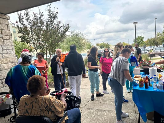 Residents and staff enjoying a community event outdoors.