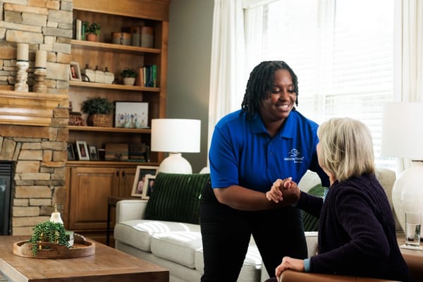 Caregiver interacting with a resident in a cozy living room