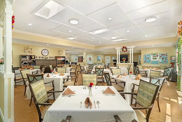 Bright dining room with tables set for meals