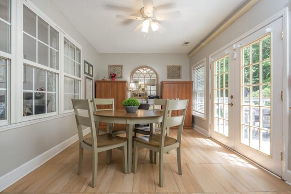 Bright common area with dining table and chairs