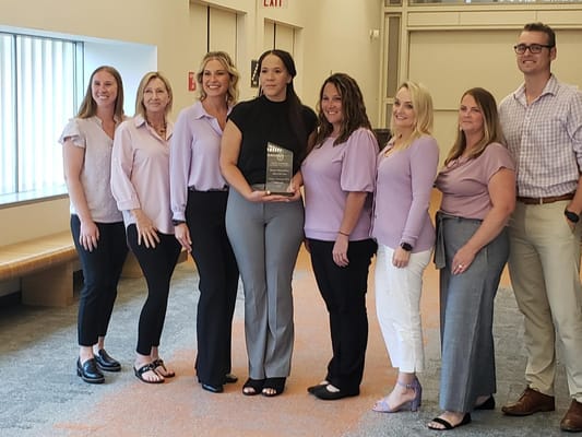 Group of staff members posing in the facility's interior