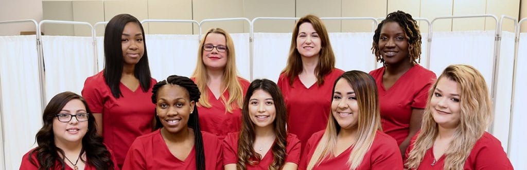 Staff members posing together in a healthcare setting