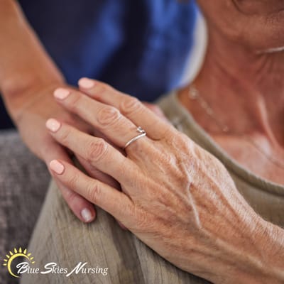 Logo of Blue Skies Nursing with a warm graphic sun