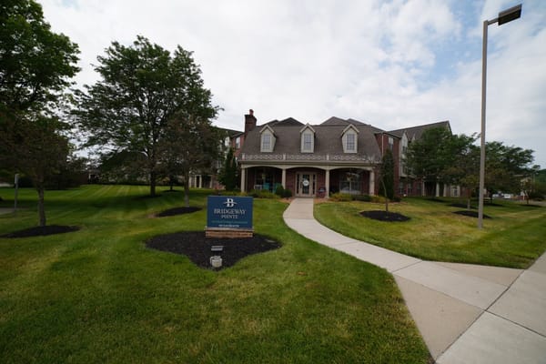 Exterior view of Bridgeway Pointe entrance with landscaping