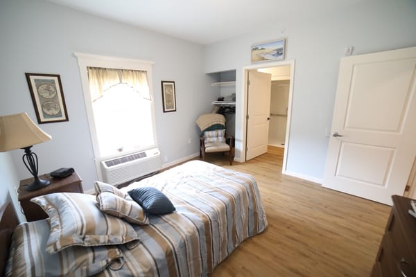 Cozy private resident room with a bed and chair