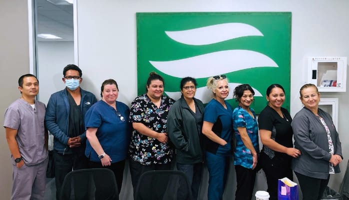 Staff members posing in a facility common area