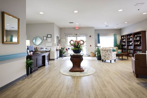 Bright interior of a common area with seating and bookshelves