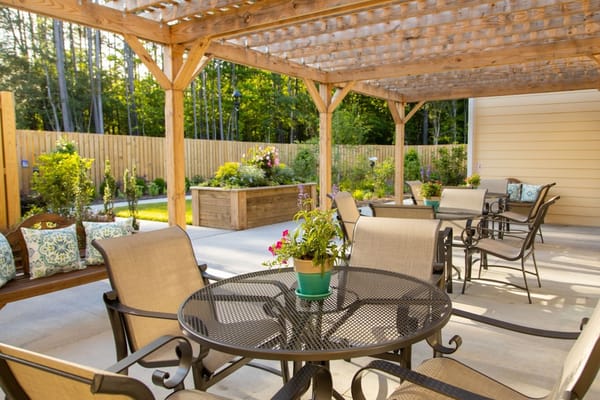 Covered outdoor seating area with garden views