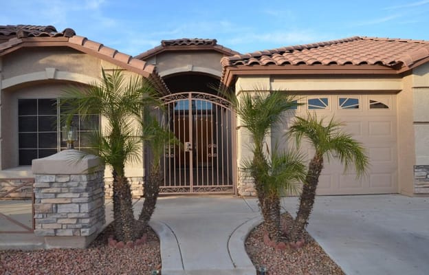 Entrance with gated entry and landscaped front yard
