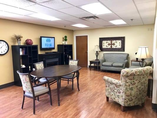 Bright common area with seating and a TV