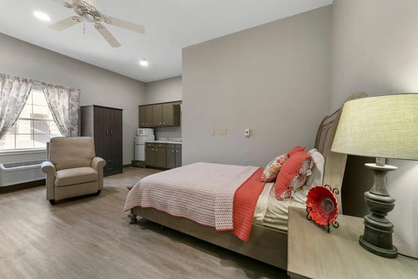 Cozy private resident room with a bed and chair