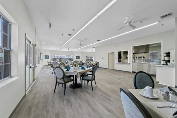 Bright dining room with tables set for residents