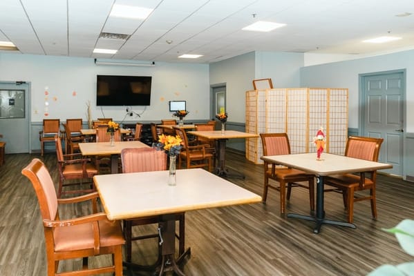 Bright common area with tables and chairs
