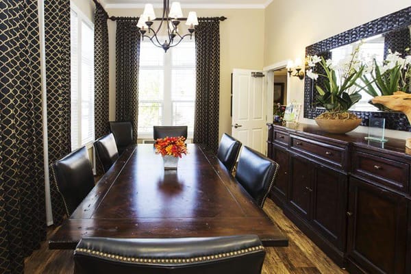 Elegant dining room with a large table and decorative flowers