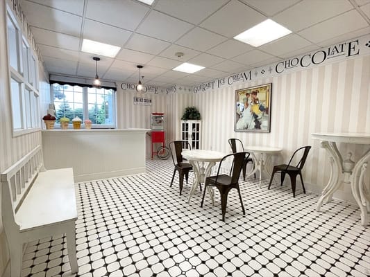 Bright common area with cafe tables and decor