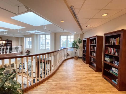 Bright interior view of a facility's common area with bookshelves