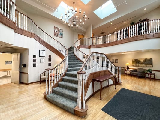 Interior view of a nursing home lobby with staircase