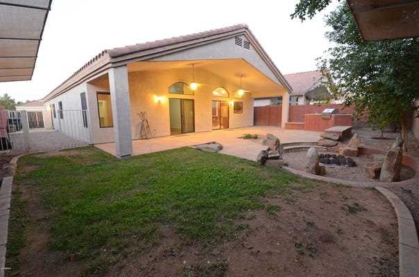 Backyard area with patio and landscaping at Comfort Assisted Living Home 2