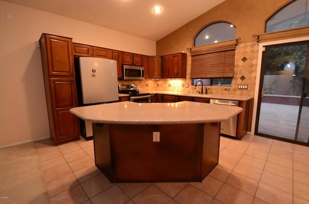 Spacious kitchen featuring wooden cabinets and a granite countertop