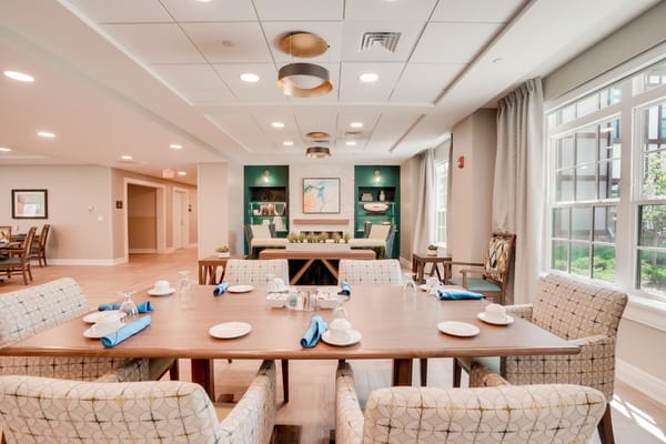 Dining area with a well-set table and decorative walls