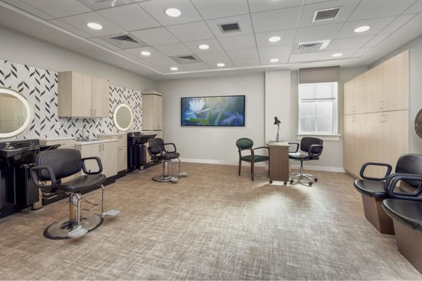 Bright salon area with styling chairs and modern decor