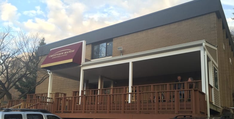 Exterior view of Crestview Manor assisted living facility with a porch