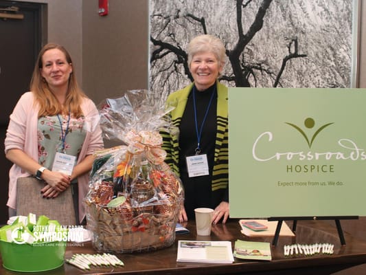 Staff members with a gift basket at an event