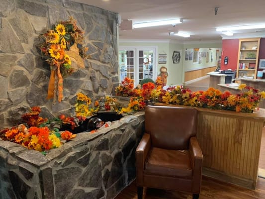 Interior decorated with seasonal flowers and a cozy chair