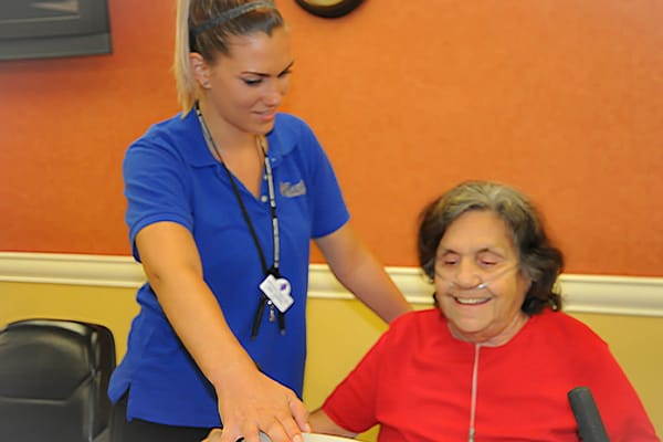 Staff assisting a resident in a communal setting
