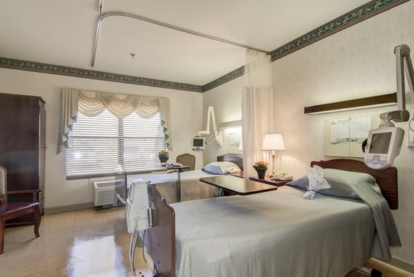 A resident room with two beds and window