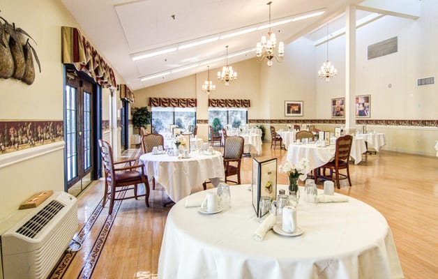 Bright dining room with tables set for meals