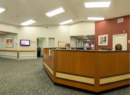 Reception area with staff at desks in a facility