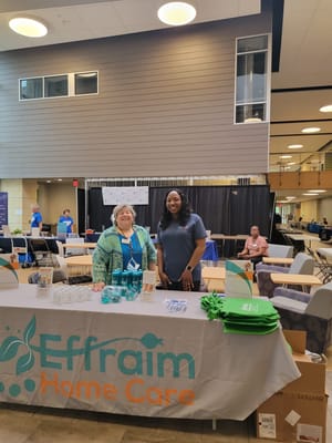 Staff members at a promotional table for Effraim Home Care